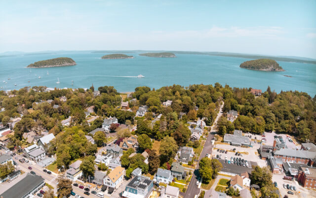 Aerial view of a coastal town and bay with boats.