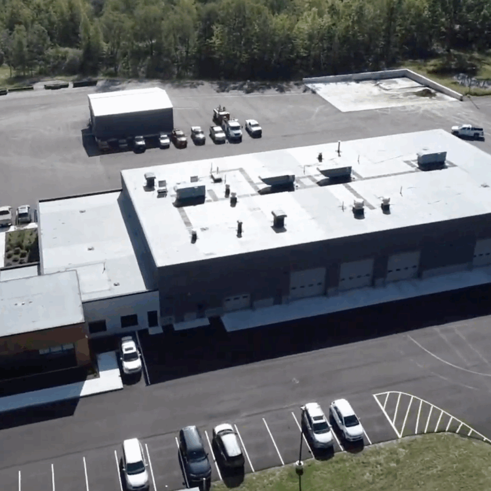 Aerial view of a large industrial building with garage bays.